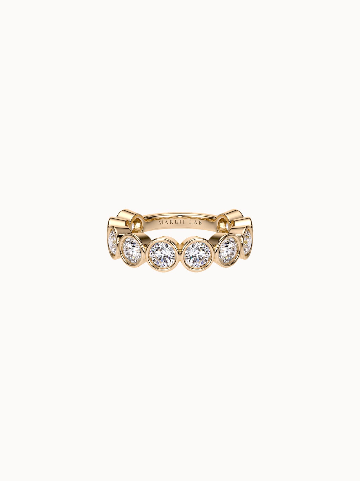 East-West Bezel Round Band Grand in 18K yellow gold, round diamonds bezel set in a row
