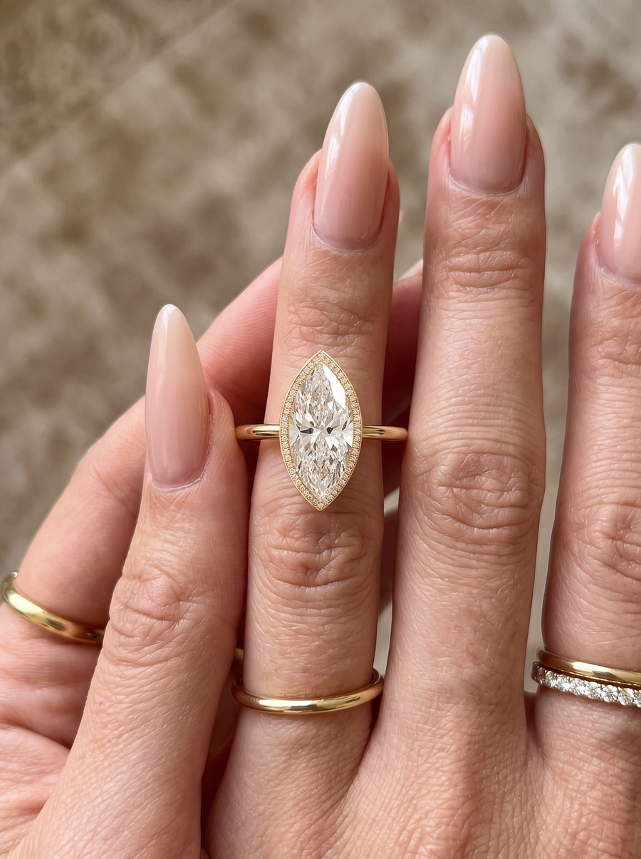Pavé Bezel Marquise engagement ring by MARLII LAB — marquise centre diamond, bezel setting, 18K Yellow Gold, worn on the hand